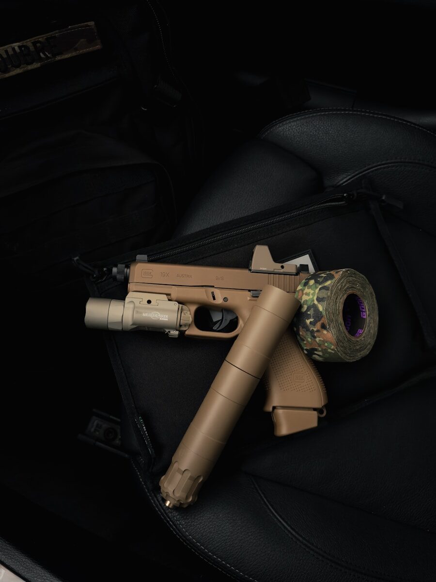 $200 Tax Stamp Removal Not Enough in the Deregulation of Suppressors. The 2nd Amendment is Still Being Infringed Tan pistol with suppressor and camouflage tape