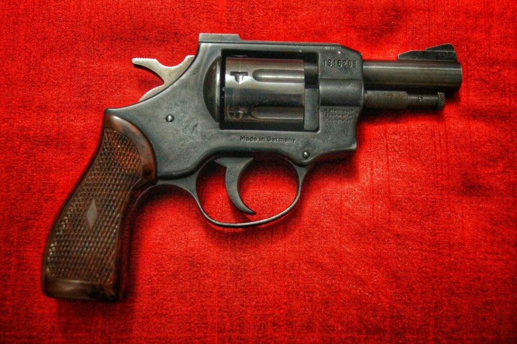 Indiana Man Charged After Changing Story in Fatal Shooting of Wife Holding Infant black and silver revolver on red textile